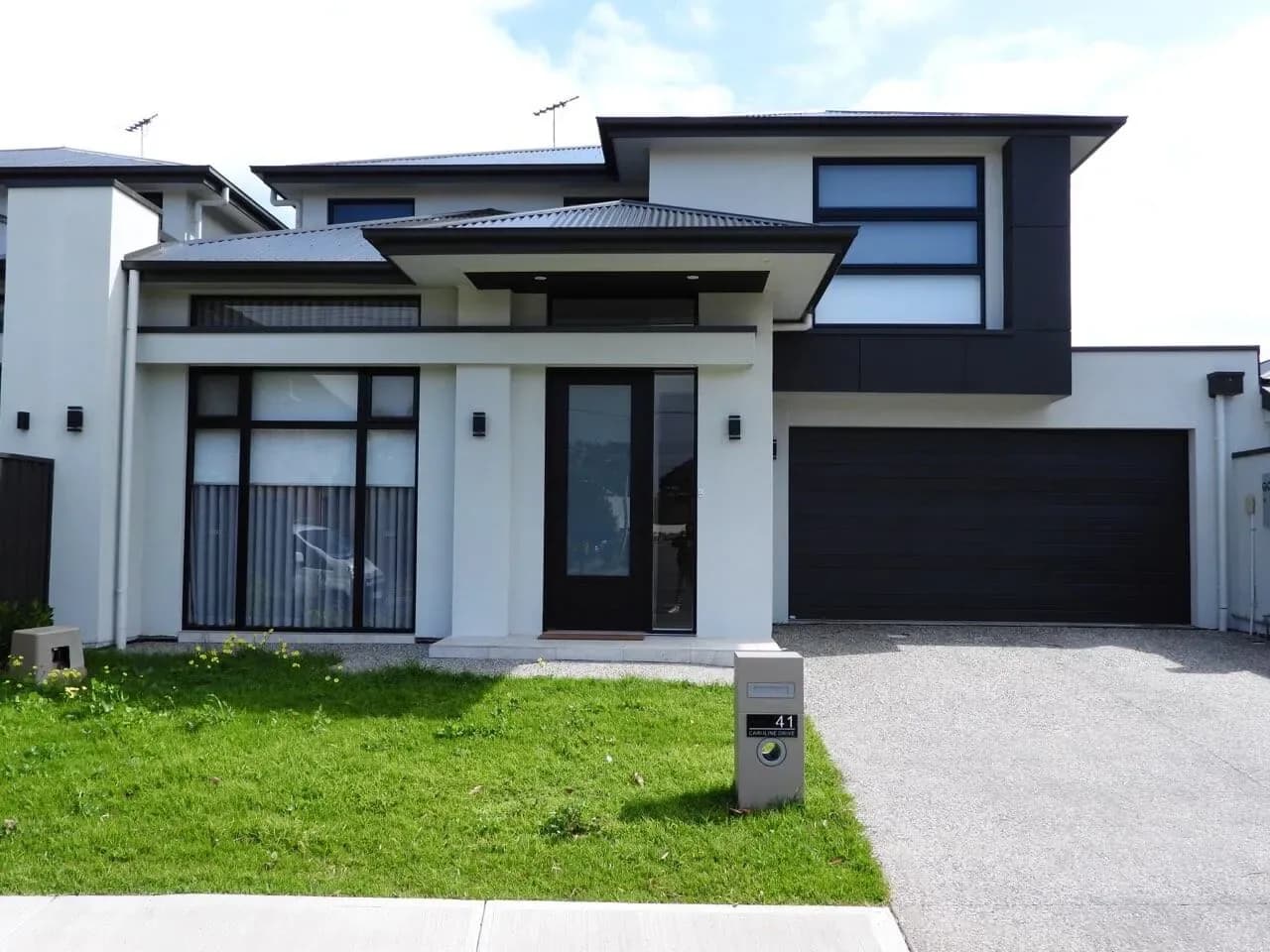Completed residential exterior with dark feature cladding