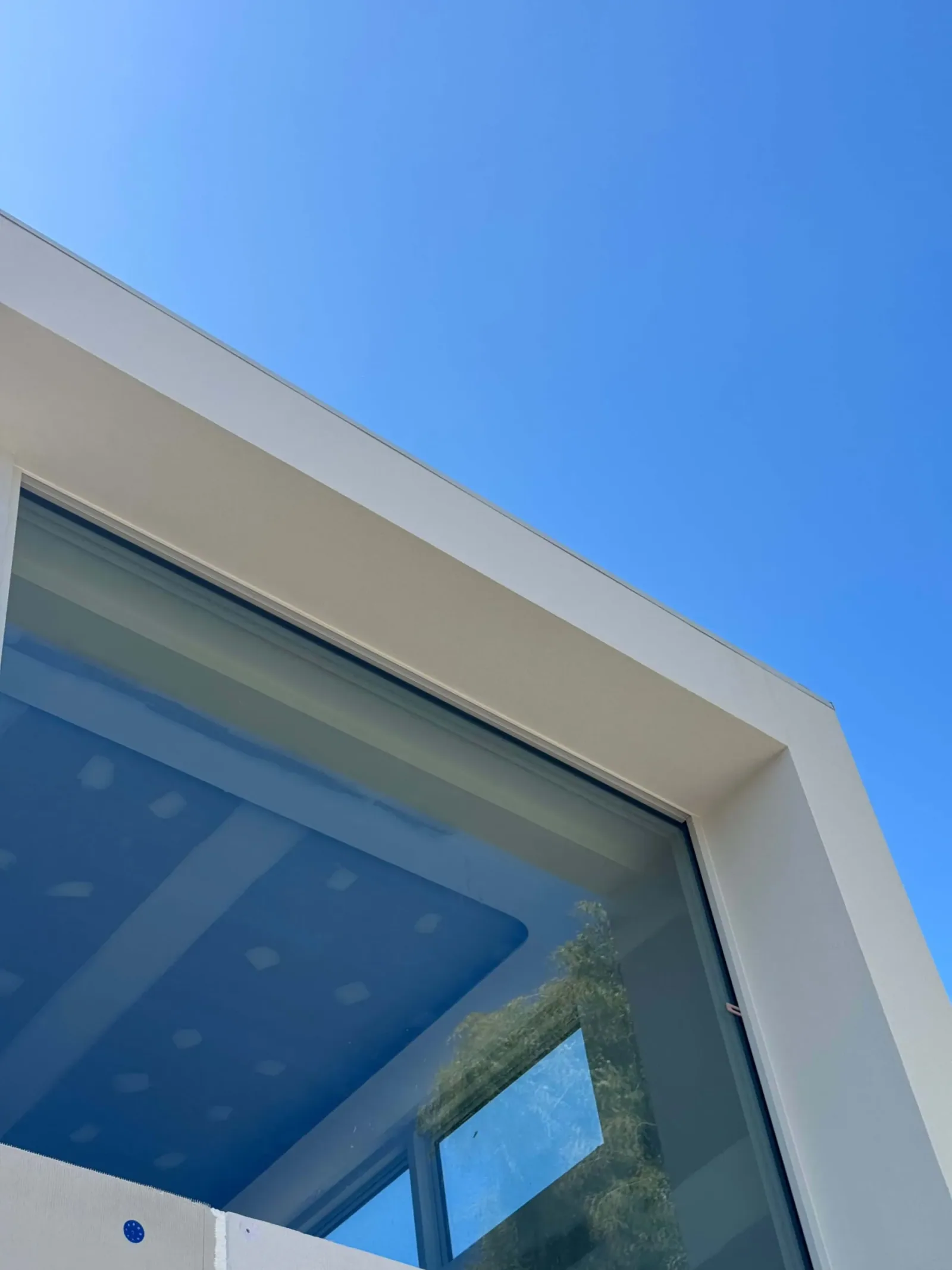 Close view of a rendered window reveal and upper parapet