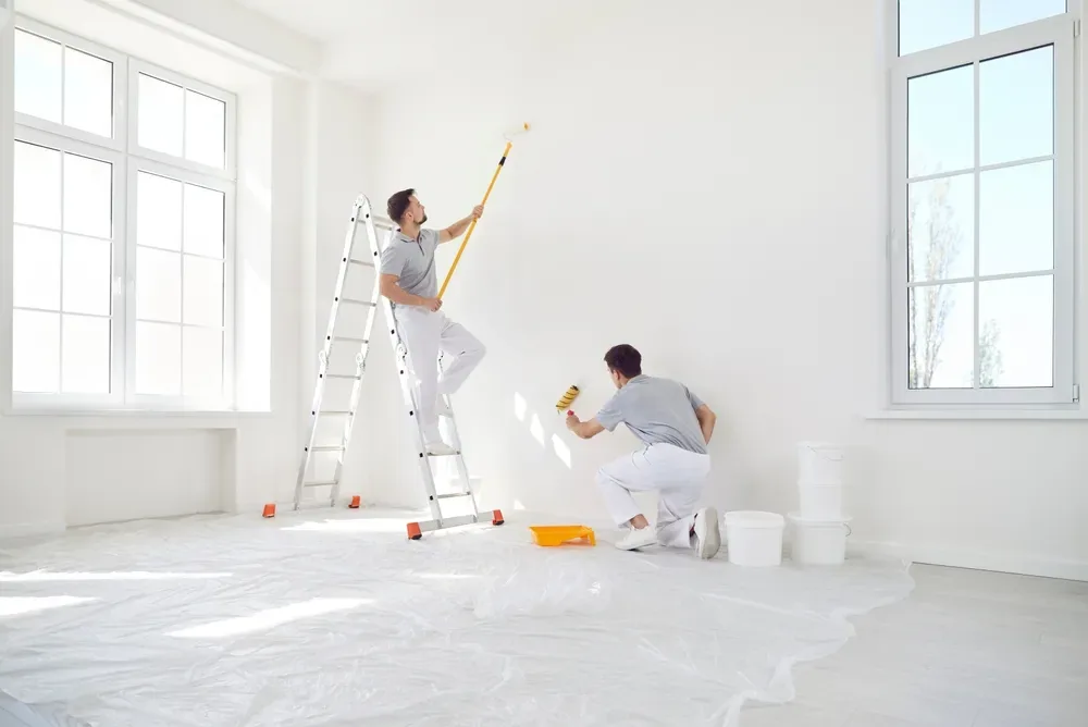 Tradespeople rendering an interior wall
