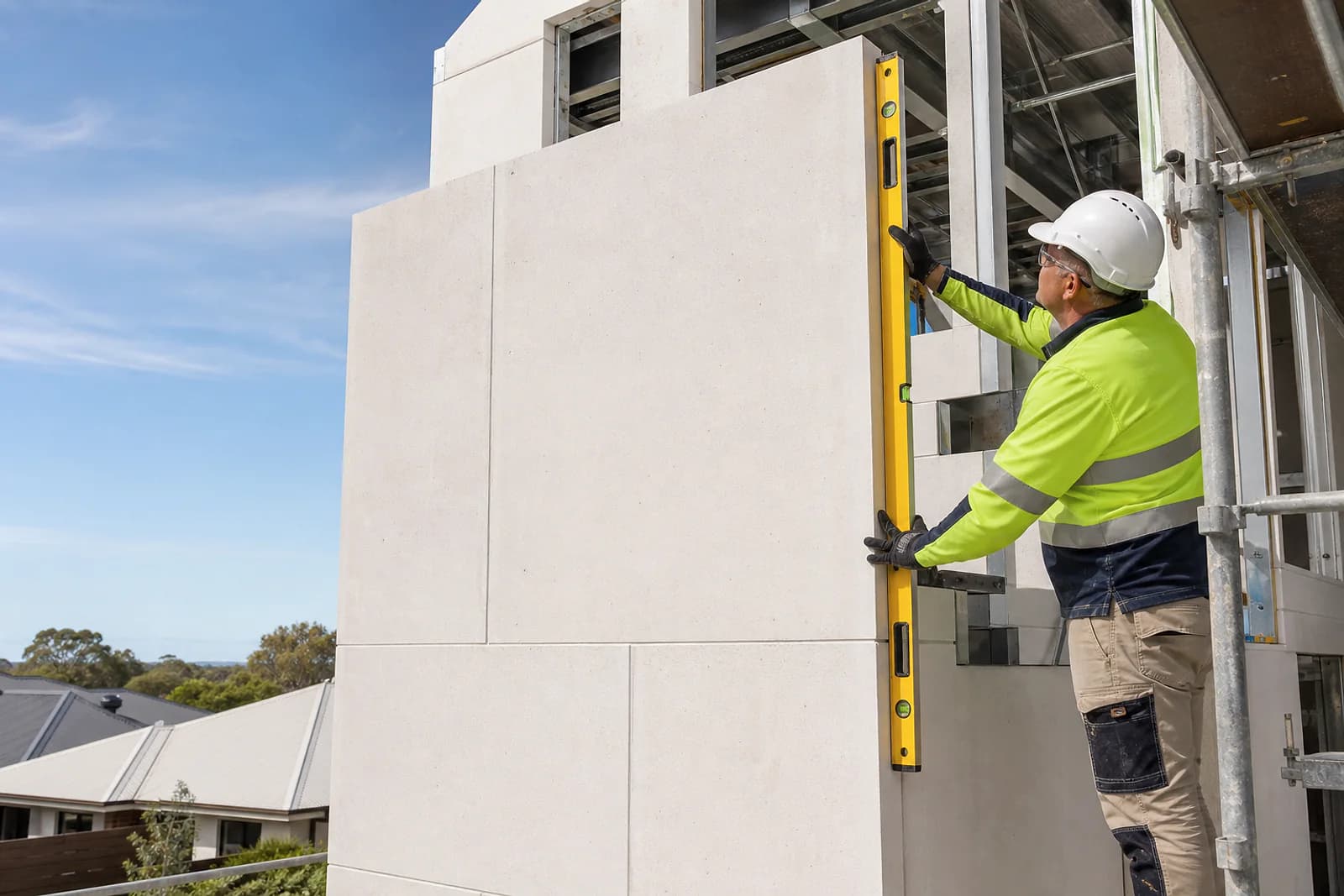 Installer checking lightweight AAC wall panels on a new Adelaide build
